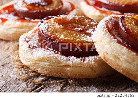 Cakes of puff pastry with plums macro horizontal 21264368