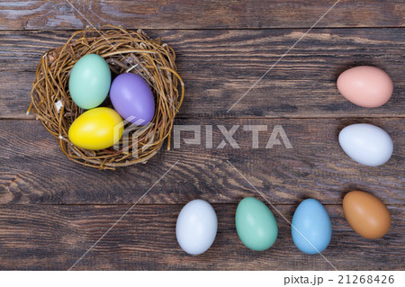 Easter colorful eggs in bird nest on wood 21268426