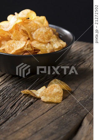 Bowl of Potato Chips on rustic background. 21272502