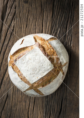 Sourdough loaf of bread on a rustic wood table. 21272504