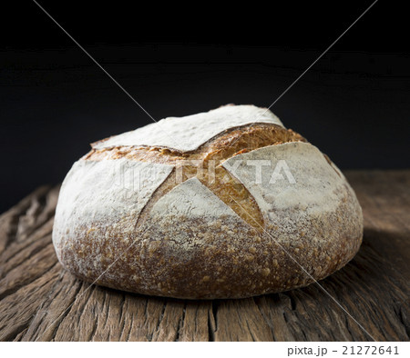 Sourdough loaf of bread on a rustic wood table. Sourdough loaf of bread on a rustic wood table. 21272641