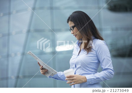 Asian business woman reading a newspaper. Asian business woman reading a newspaper. 21273049