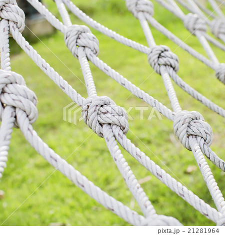 View through the safety net at the green grass  21281964
