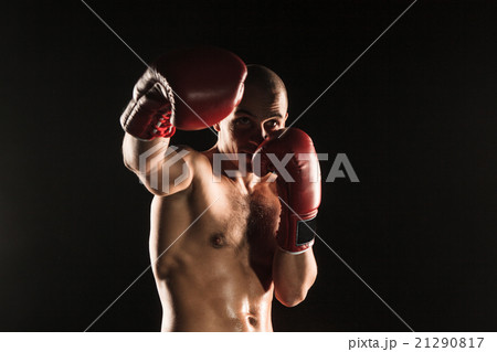 The young man kickboxing on black 21290817