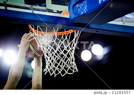 Basketball going through the hoop  21293357