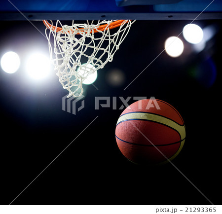 Basketball going through the hoop  21293365