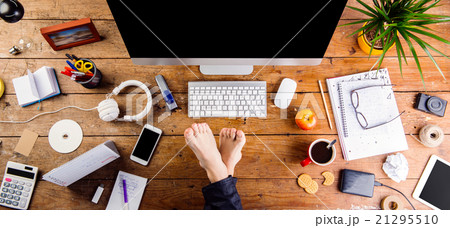 Businessman working in his office with feet on 21295510