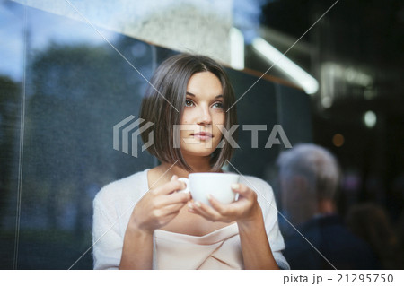 Beautiful woman with coffee cup restaurant window 21295750