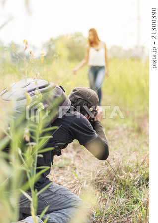 Man photographing young beautiful woman against  21300390