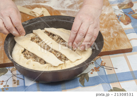 Raw dough with filling in black metal baking form Raw dough with filling in black metal baking form 21308531
