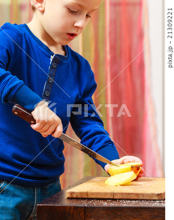 Child cut apple with a kitchen knife, cooking. Child cut apple with a kitchen knife, cooking. 21309221