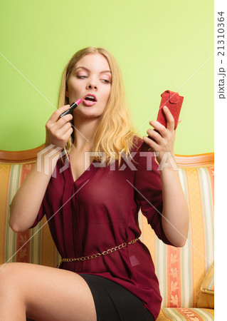 Attractive woman applying lipstick. Make up. 21310364