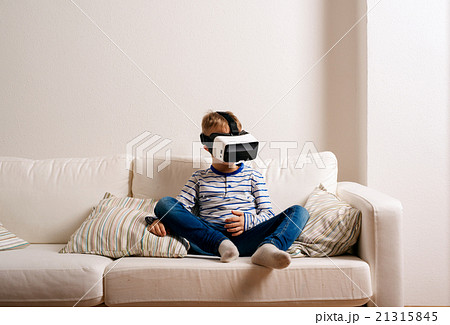 Boy wearing virtual reality goggles. Studio shot 21315845