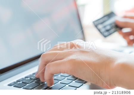 Hands holding a credit card and using laptop computer for online Hands holding a credit card and using laptop computer for online 21318906