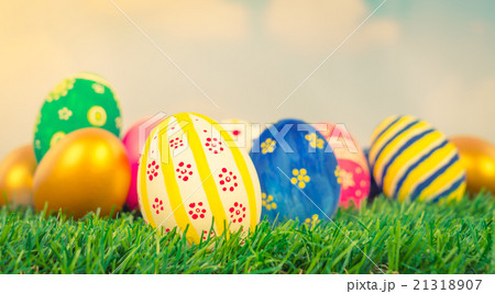 Easter Eggs on Fresh Green Grass over blue sky ( Filtered image Easter Eggs on Fresh Green Grass over blue sky ( Filtered image 21318907