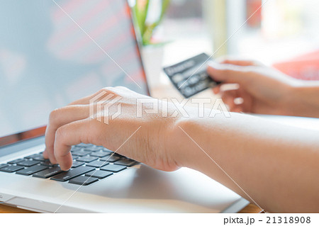 Hands holding a credit card and using laptop computer for online 21318908