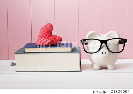 Piggy Bank with Glasses Beside Books with Heart 21320004