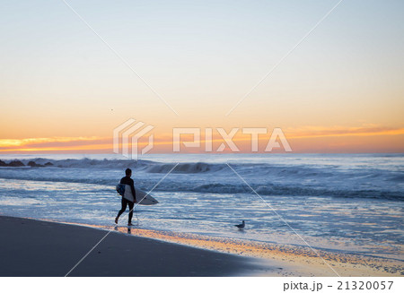Surfer about to paddle out 21320057