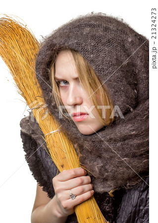 Angry woman in a scarf with a broom in his hand Angry woman in a scarf with a broom in his hand 21324273