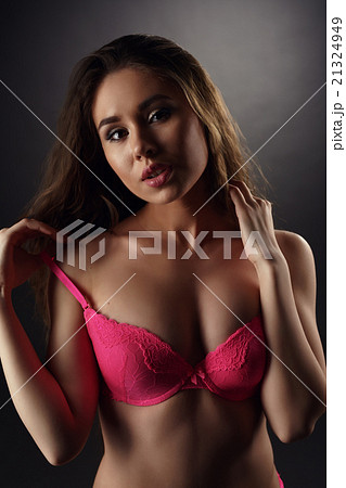 Sexy brunette pulled down strap of her brassiere 21324949