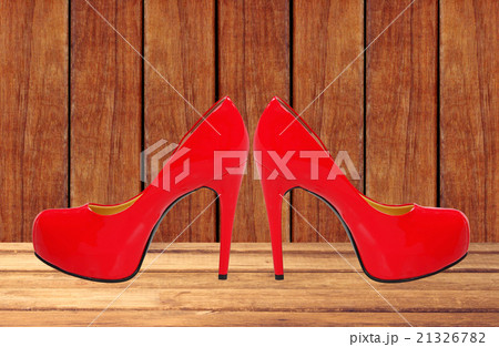 red high heeled woman shoes on wooden table 21326782