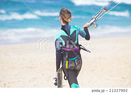 Female kiteboarder with kiteboarding equipment. 21327902
