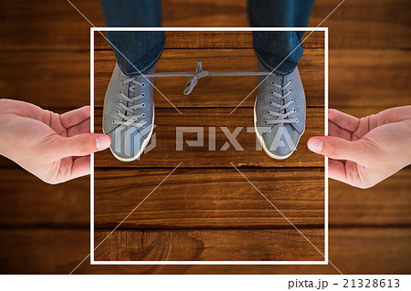 Composite image of hands holding black paper 21328613