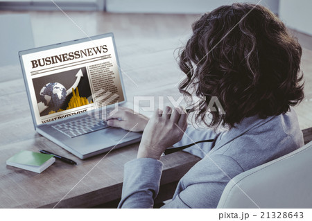 Composite image of businesswoman using laptop at desk in creativ Composite image of businesswoman using laptop at desk in creativ 21328643
