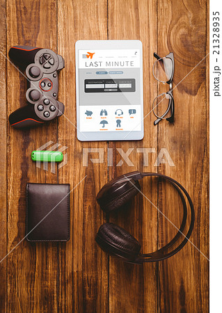 Composite image of tablet and glasses next to joystick music hea Composite image of tablet and glasses next to joystick music hea 21328935