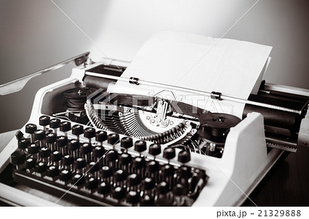Old typewriter on wooden table. Vintage style Old typewriter on wooden table. Vintage style 21329888