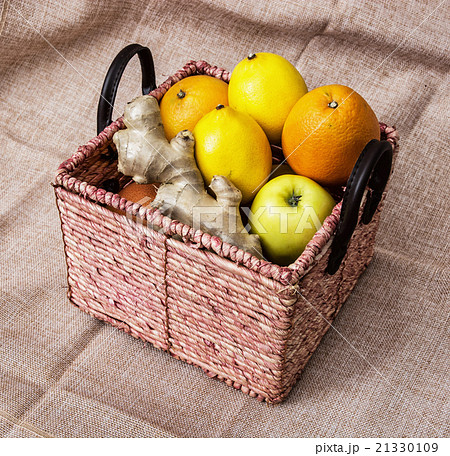 Wicker basket with apples, oranges, lemons and ginger - healthy Wicker basket with apples, oranges, lemons and ginger - healthy 21330109