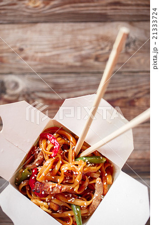 Noodles with pork and vegetables in take-out box 21333724