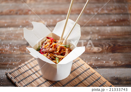 Noodles with pork and vegetables in take-out box 21333743