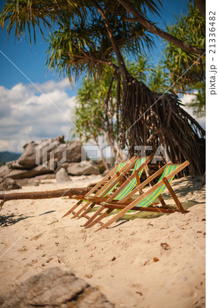 Beach lounge chairs on sandy beach Beach lounge chairs on sandy beach 21336482