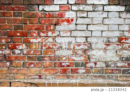 Old brick wall with big white spot of old paint 21338342