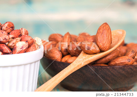 Almonds in  bowl on wooden background 21344733