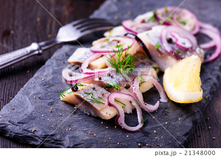 Sliced herring on a black slate plate 21348000