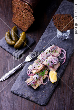Sliced herring on a black slate plate Sliced herring on a black slate plate 21348001