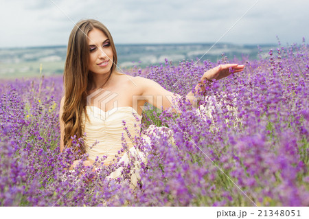 Beautiful girl is sitting at lavender field Beautiful girl is sitting at lavender field 21348051