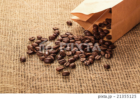 beautiful whole coffee beans spill out of a paper beautiful whole coffee beans spill out of a paper 21355125