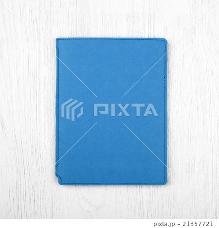blue notebook on white wooden table, top view 21357721