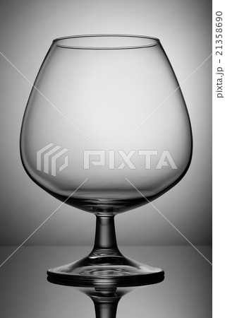 Empty glass snifter on the leg. For beverages. 21358690