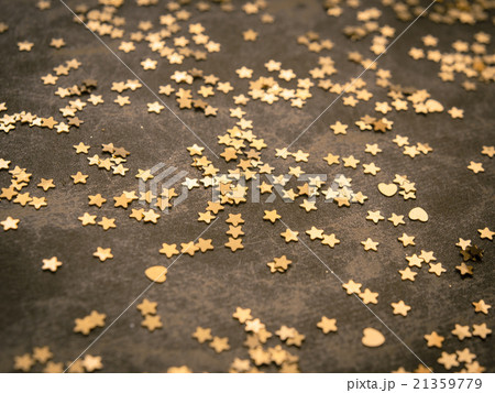 Golden stars on dark brown background 21359779