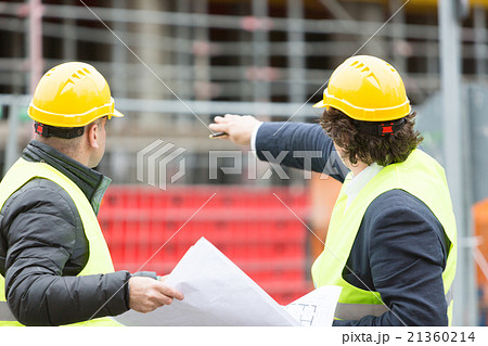 Two engineers pointing at scaffolding Two engineers pointing at scaffolding 21360214