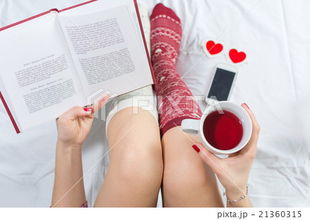 Woman reading a book in bed 21360315