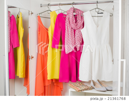 row of bright colorful dress hanging 21361768