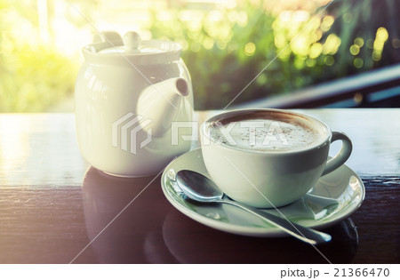Cup of coffee with hot tea pot on wooden Cup of coffee with hot tea pot on wooden 21366470