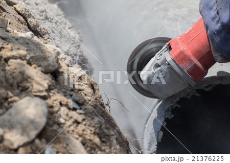 Plumbers cutting concrete water pipes 21376225