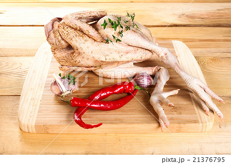 Fresh raw chicken carcass wooden board with pepper Fresh raw chicken carcass wooden board with pepper 21376795