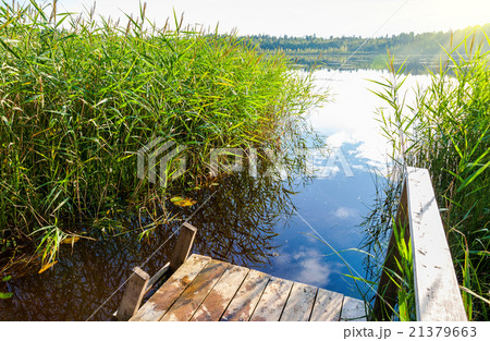 Summer landscape with lake and wooden bridge Summer landscape with lake and wooden bridge 21379663